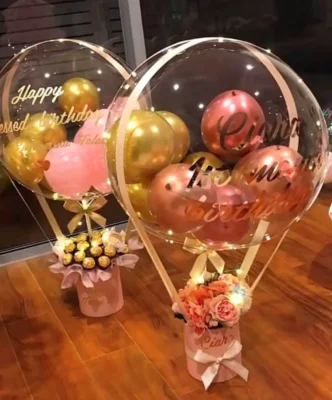balloon bucket with colour pink and gold, with flowers or Ferrero chocolate balls.
