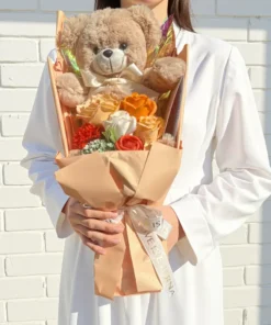 champagne soap flower and teddy bear bouquet with gift box Held in hands