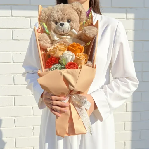 champagne soap flower and teddy bear bouquet with gift box Held in hands