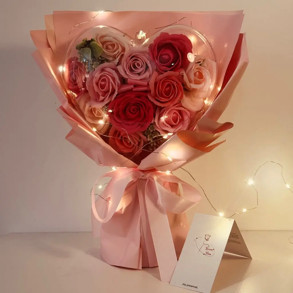 blooms in heart shell soap pink rose bouquet with string lights
